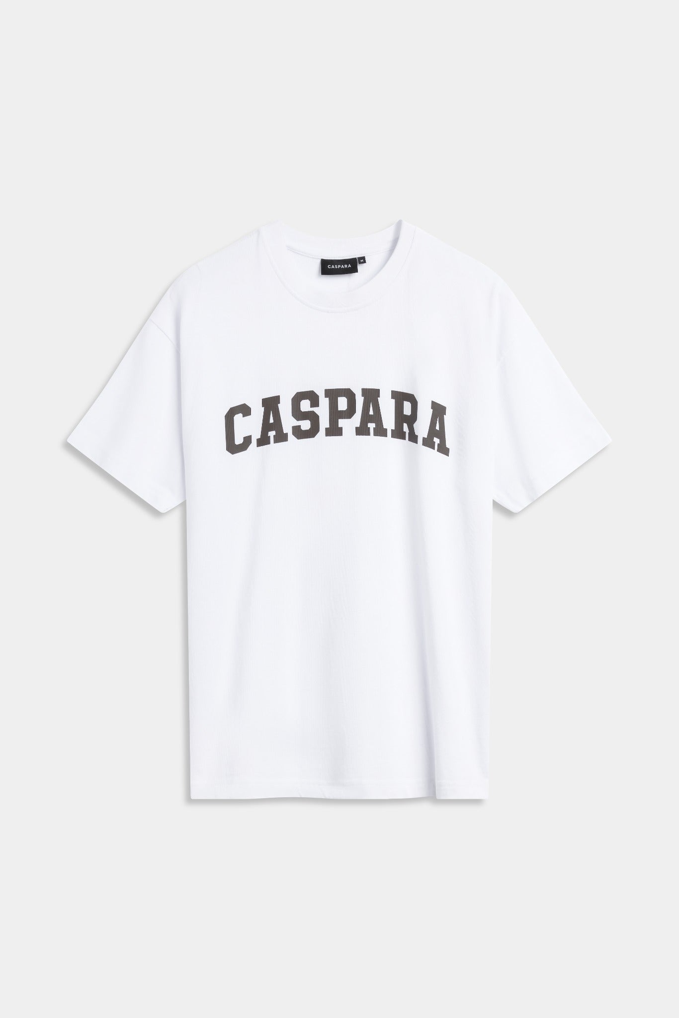White cotton oversized t-shirt with an arched espresso CASPARA logo print on a light grey background.